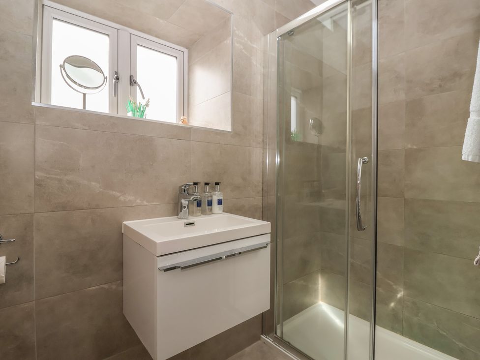 A bathroom with a glass shower and sink at Shepherd's Crook in Follifoot near Spofforth