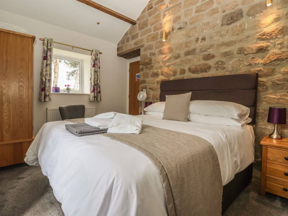 A bedroom with a bed and wardrobe at Shepherd's Crook in Follifoot near Spofforth