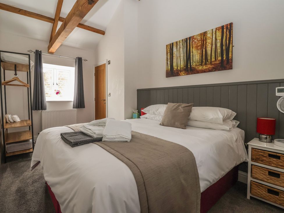 A bedroom with bed and shelf at Shepherd's Crook in Follifoot near Spofforth