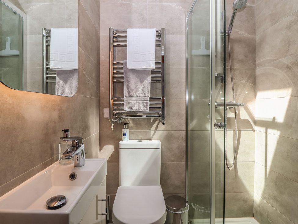 A bathroom with a shower, sink, and toilet at Shepherd's Crook in Follifoot near Spofforth