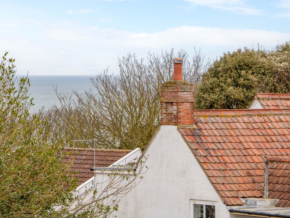 A view of rooftops and the sea at Beckhythe Cottage Overstrand