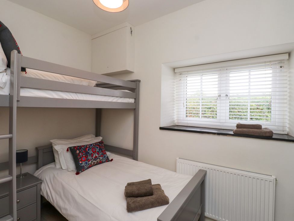 A bedroom with a bunk bed and a single bed at Pen Y Cefn