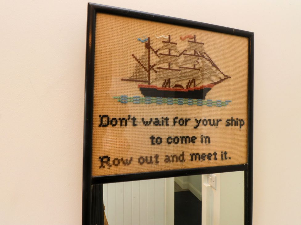 A framed artwork featuring a ship and a quote at Pen Y Cefn in Pen Y Cefn