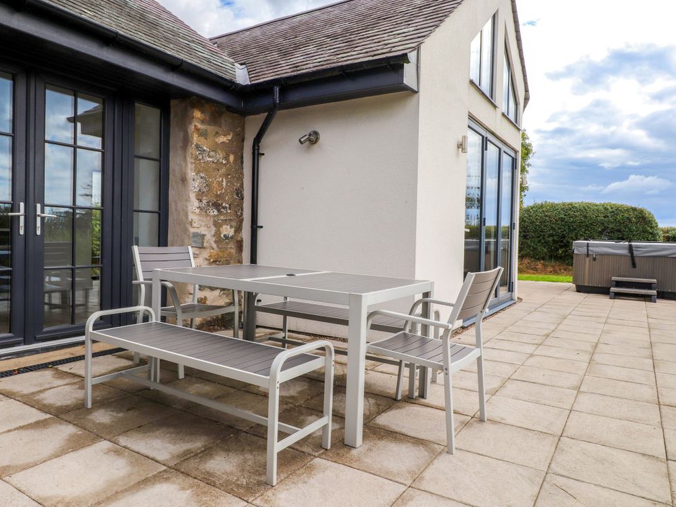 An outdoor area with a table and chairs at Pen Y Cefn