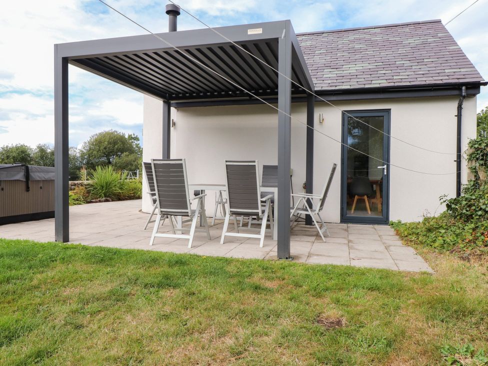 An outdoor seating area with a table and chairs at Pen Y Cefn
