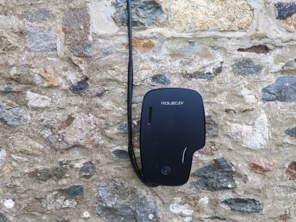 A charging unit mounted on a stone wall at Pen Y Cefn