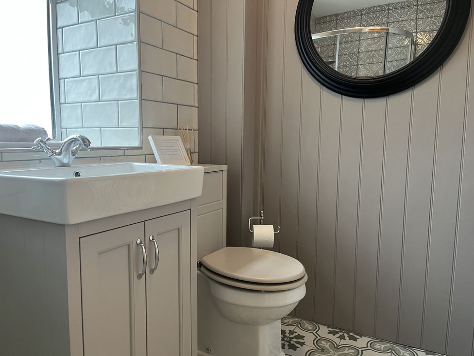 A bathroom with a sink and toilet at The Stables At Cae Gwyn in Ruthin