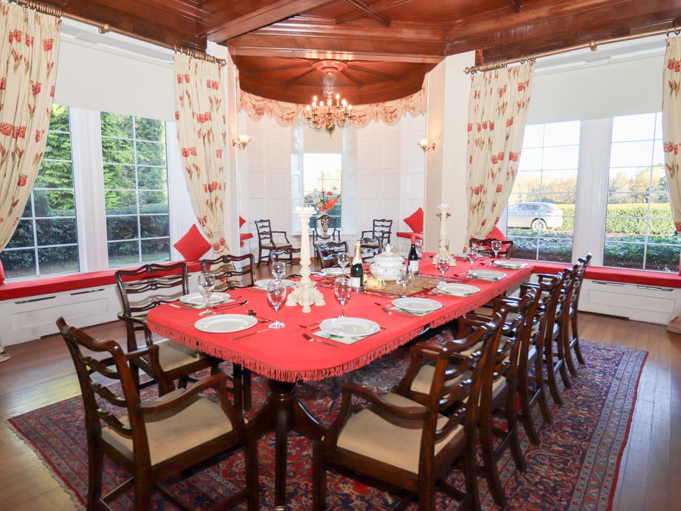 A dining room with a large table and chairs at Auchentroig House Buchlyvie