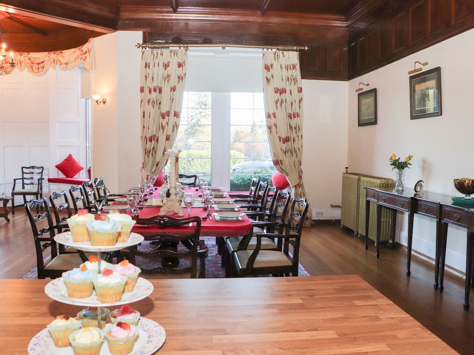 A dining room with a table set for dinner at Auchentroig House in Buchlyvie