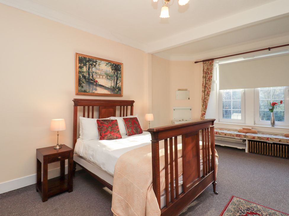 A bedroom with a bed and nightstand at Auchentroig House in Buchlyvie