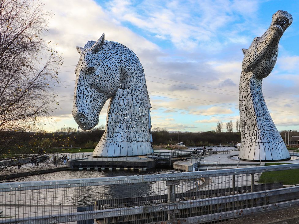 Two large horse sculptures near water at Auchentroig House in Buchlyvie