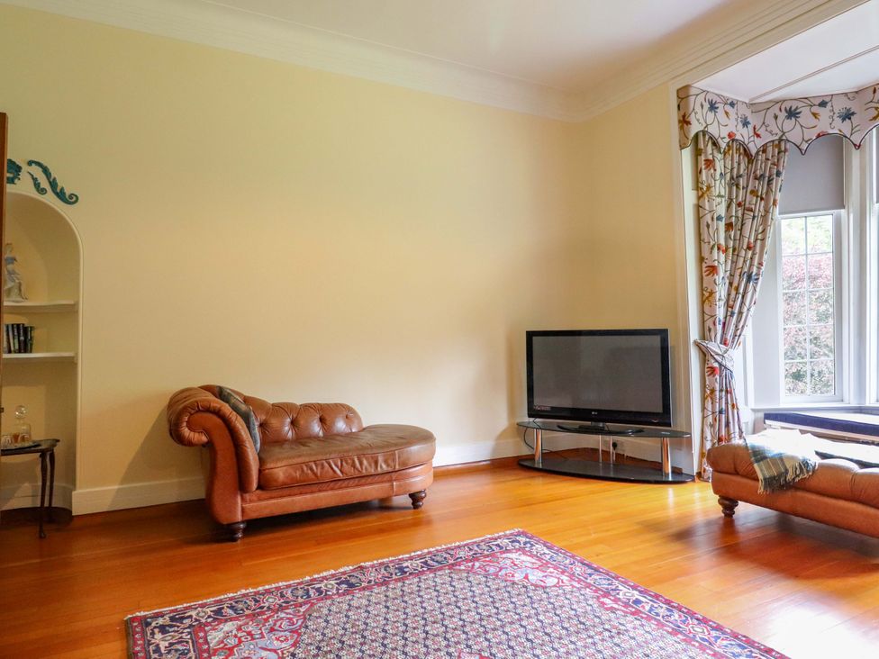 A living room with a sofa and television at Rob Roy Apartment in Buchlyvie