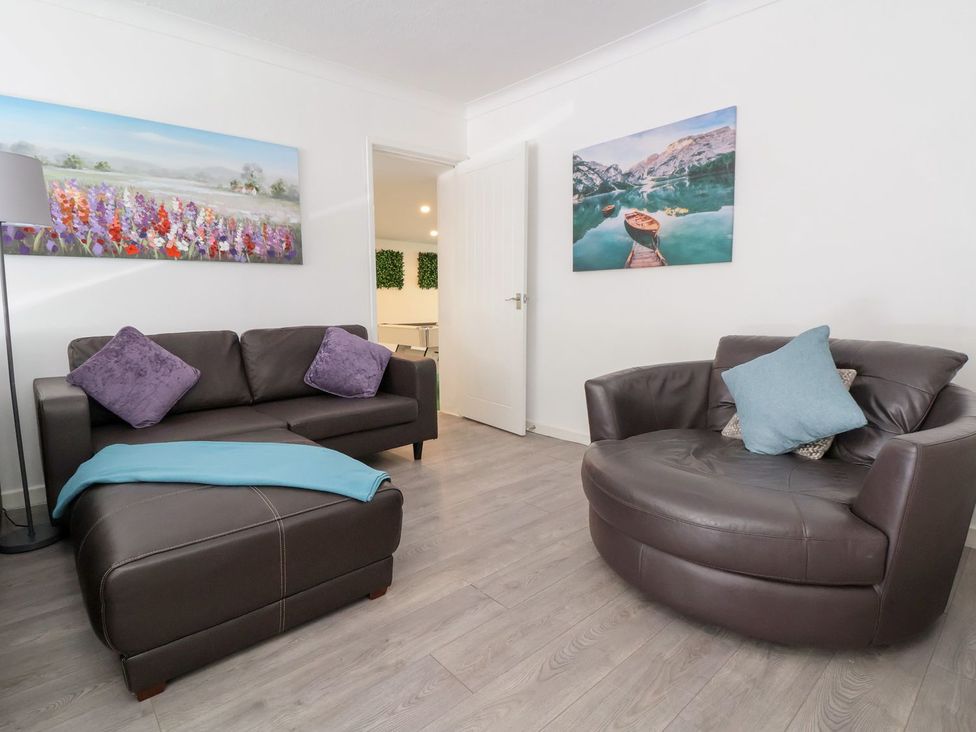 A living room with a sofa and chair at Castellolwg