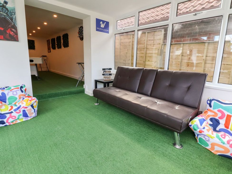 A recreational room with sofa and bean bags at Castellolwg