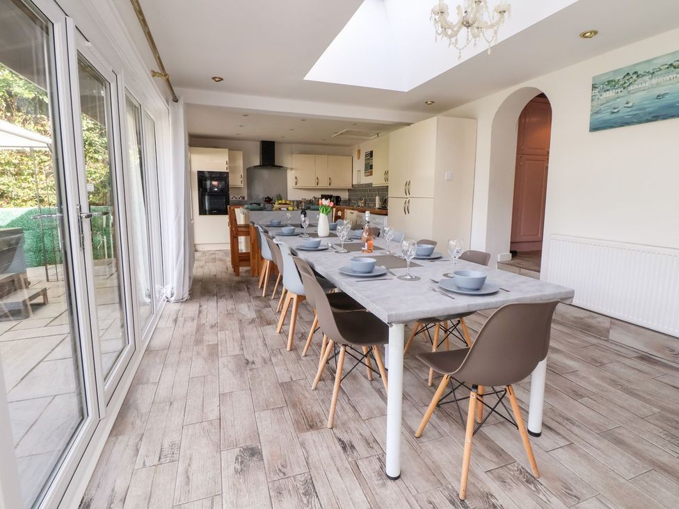 A dining room with a table set for dinner at Castellolwg