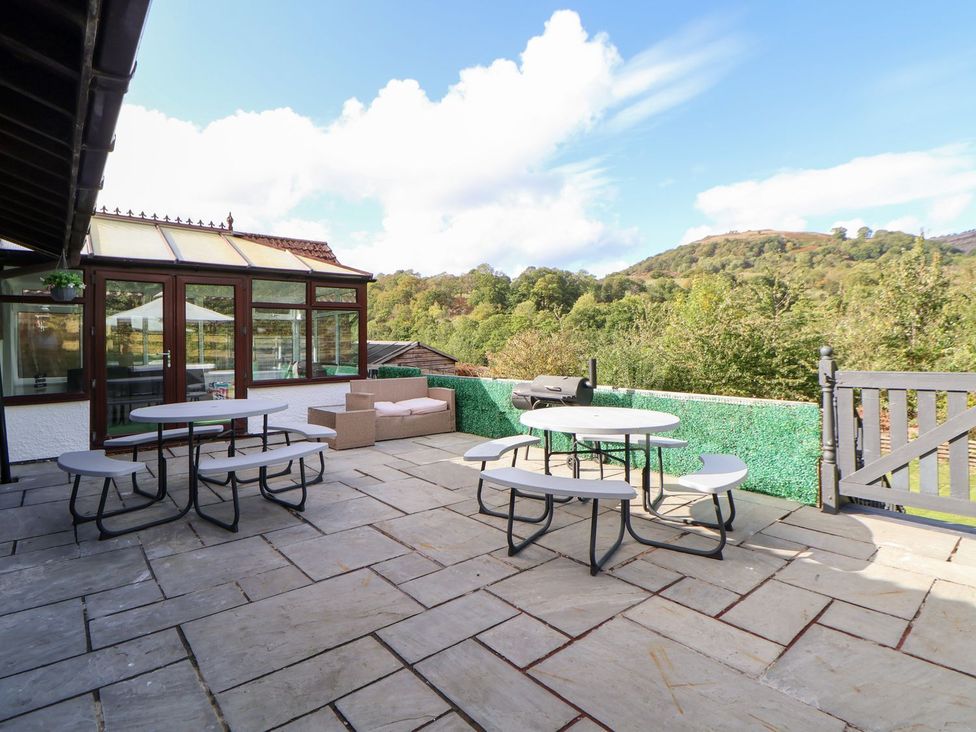 An outdoor patio with tables and seating at Castellolwg