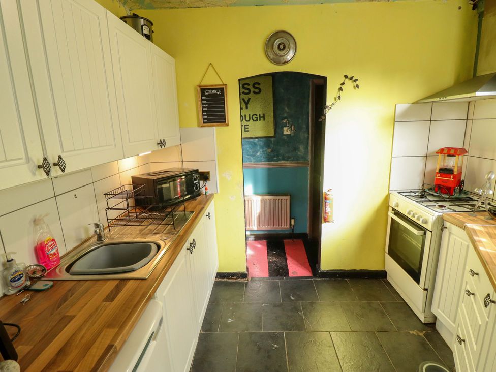 A kitchen with sink and microwave at Dormy Cottage in Skegness