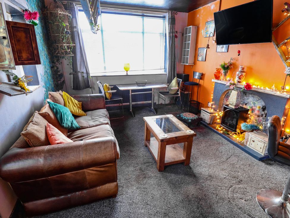 A living room with a sofa and coffee table at Dormy Cottage in Skegness