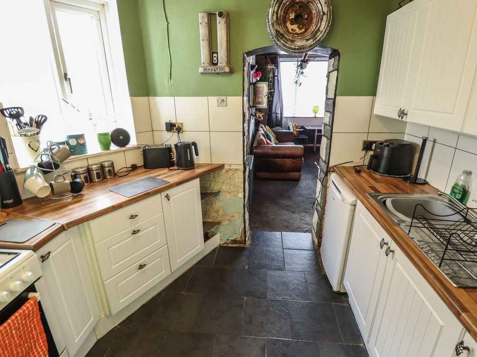 A kitchen with a sink and stove at Dormy Cottage in Skegness