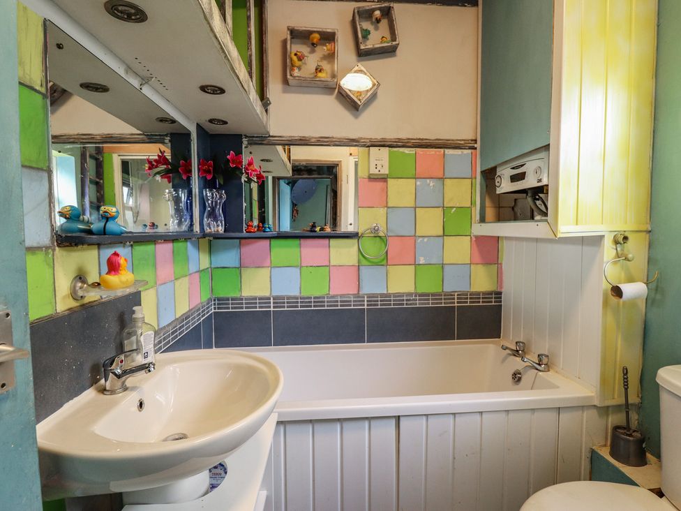 A bathroom with a sink and bathtub at Dormy Cottage in Skegness