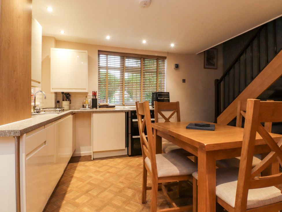 A kitchen with a dining table and chairs at Mayfield Cottage in Blackpool
