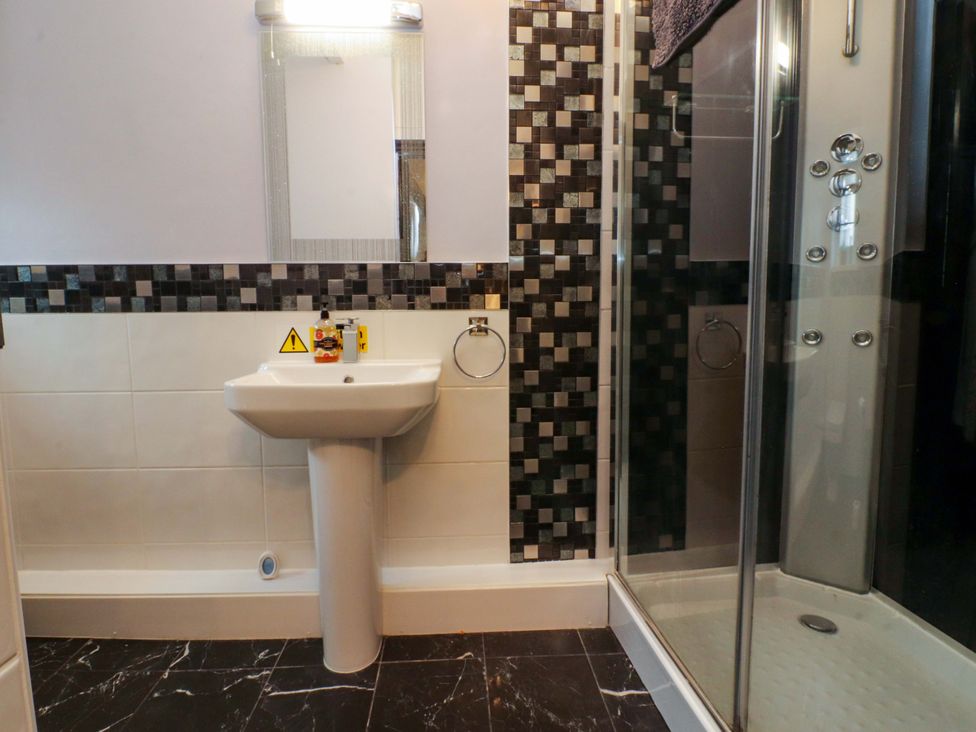A bathroom with a sink and shower at Mayfield Cottage Blackpool