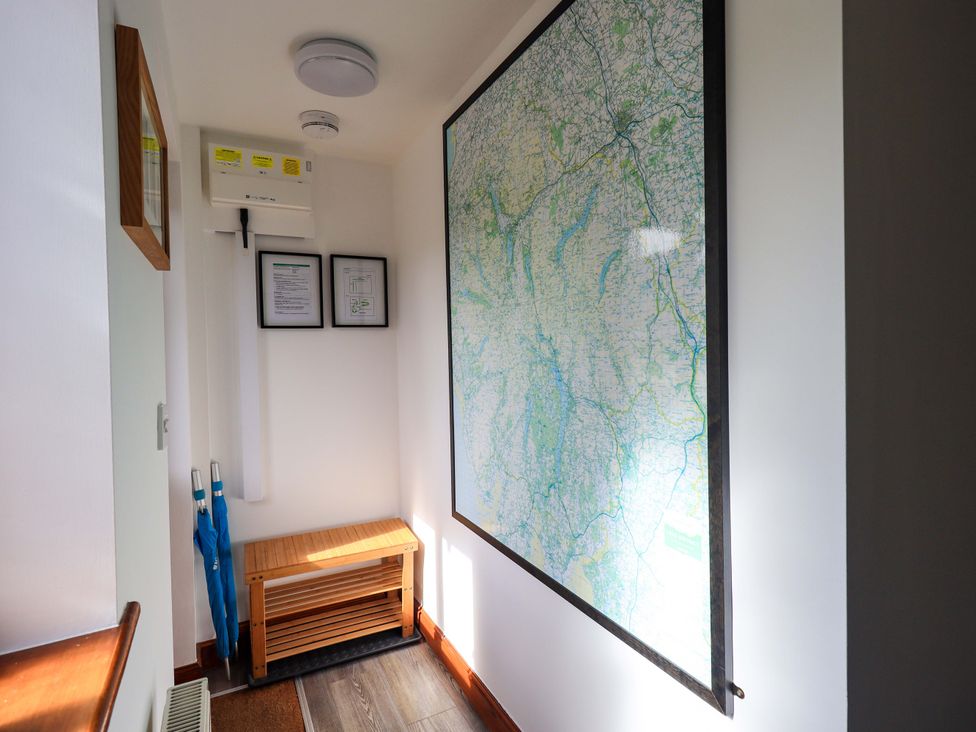 A hallway with a map on the wall and a bench at High Dow Crag in Coniston