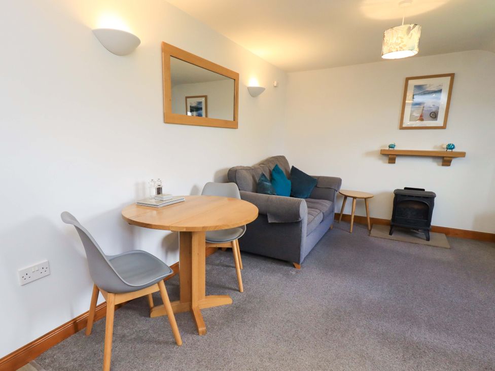 A living room with a sofa and table at High Dow Crag Coniston