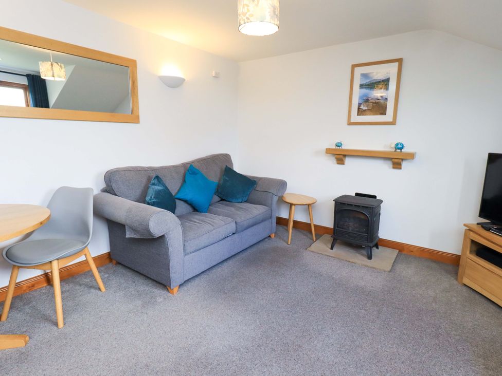 A living room with a sofa and a table at High Dow Crag in Coniston