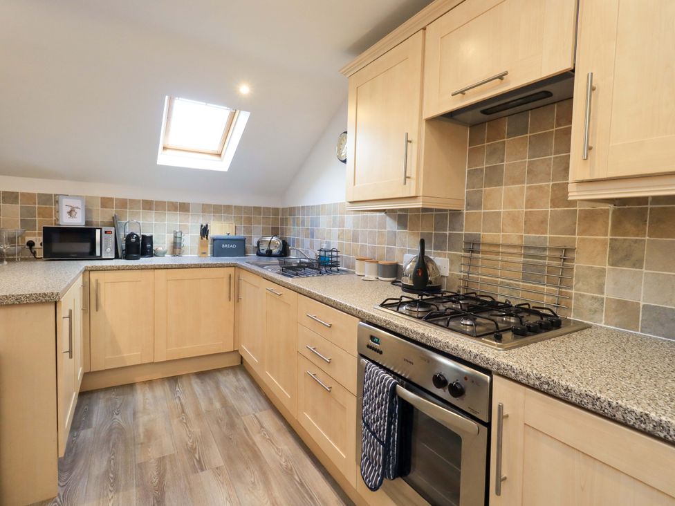 A kitchen with appliances and cabinets at High Dow Crag in Coniston
