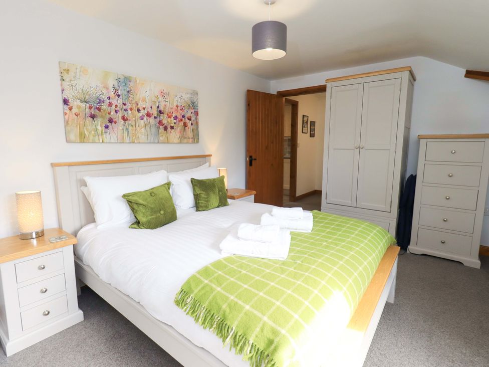 A bedroom with a bed and a wardrobe at High Dow Crag in Coniston
