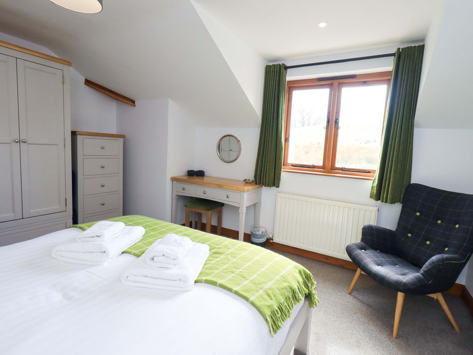 A bedroom with a bed and wardrobe at High Dow Crag in Coniston