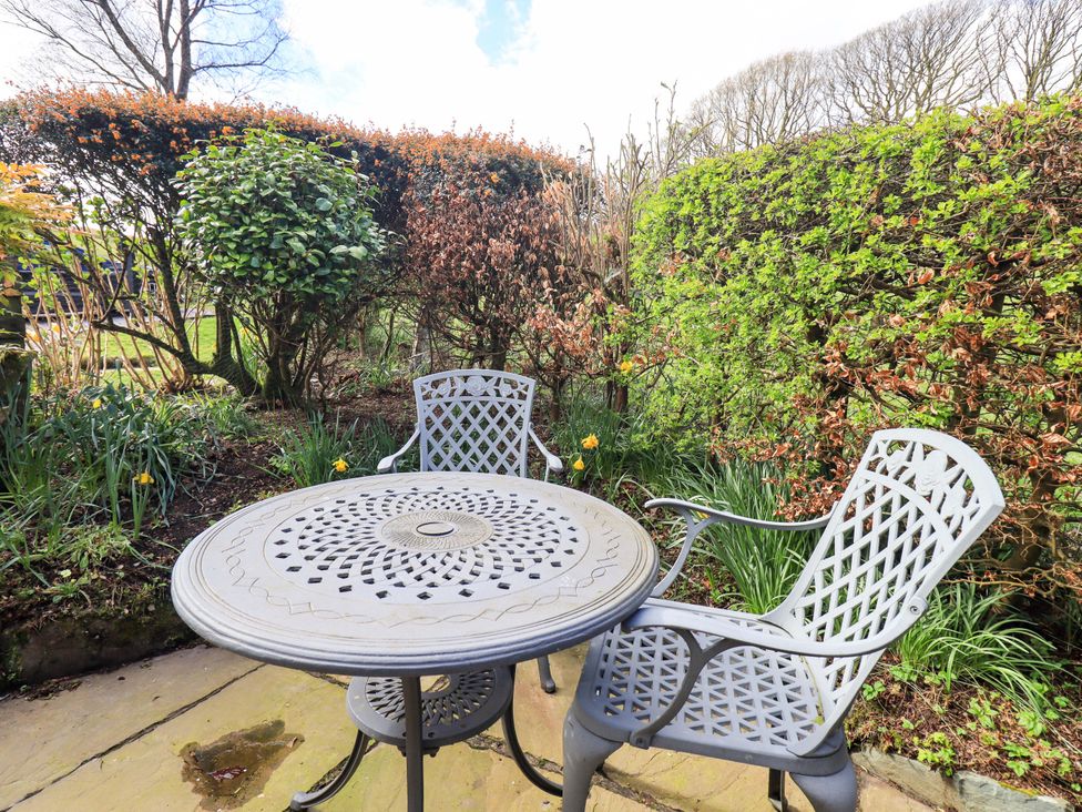 A table and two chairs in a garden at High Dow Crag in Coniston