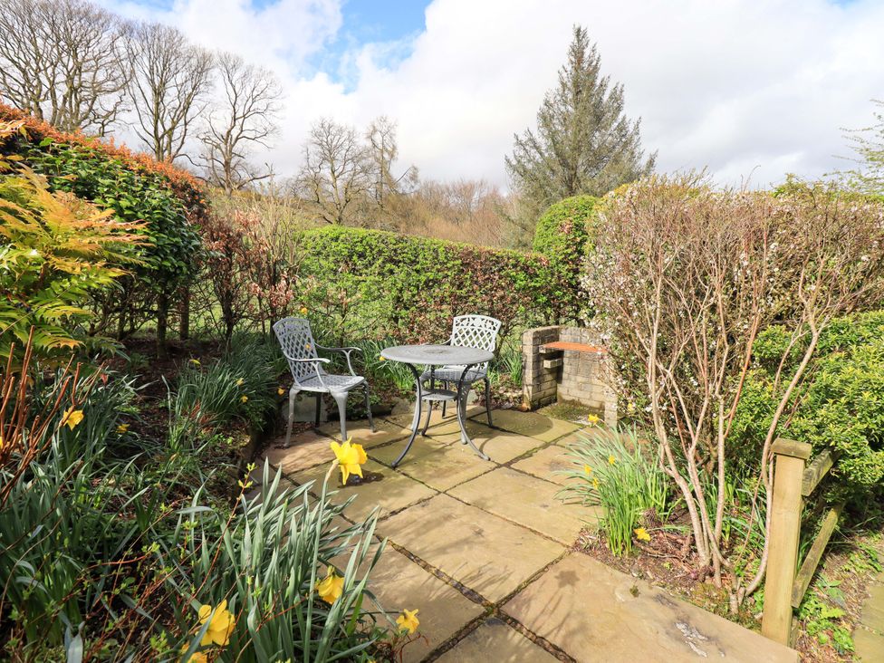 A garden area with a table and chairs at High Dow Crag in Coniston