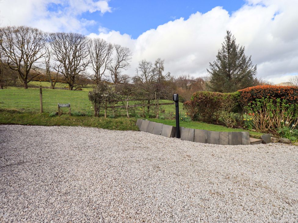 An outdoor area with gravel surface and garden features at High Dow Crag in Coniston