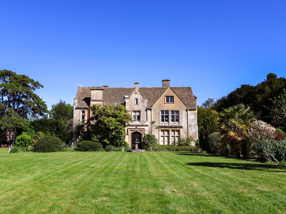 A house with a garden and trees at The West Wing 