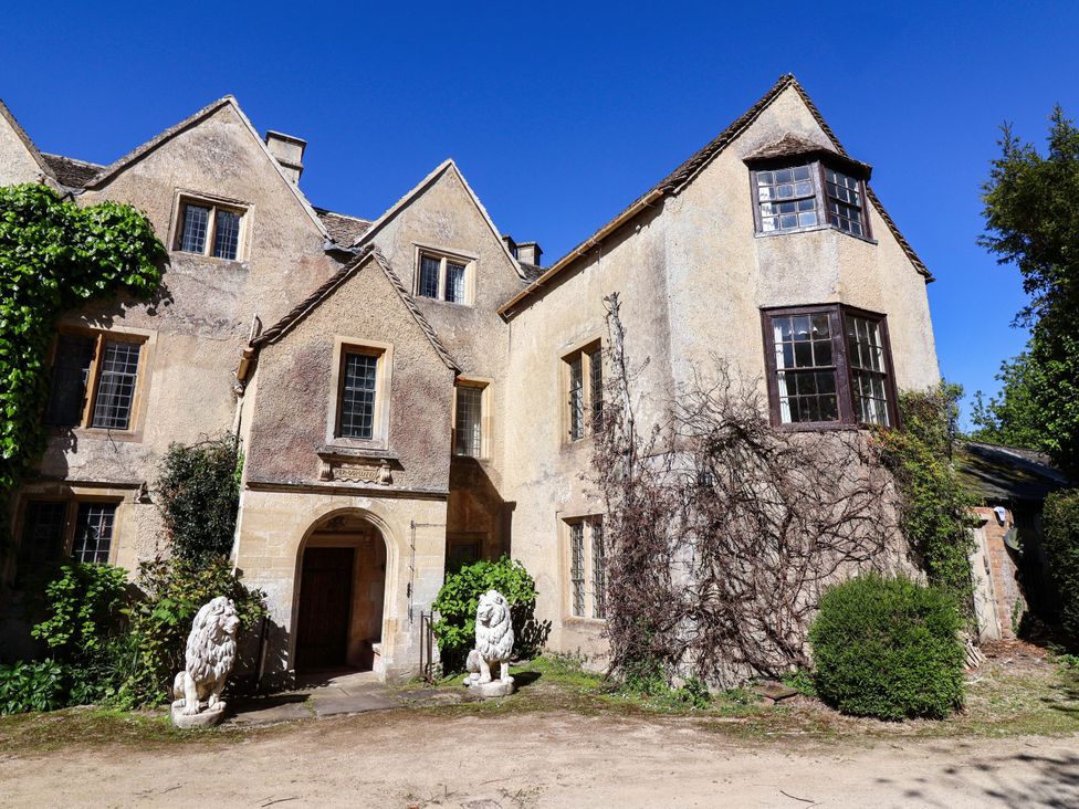 An exterior view of a house with lions at the entrance at The West Wing in 