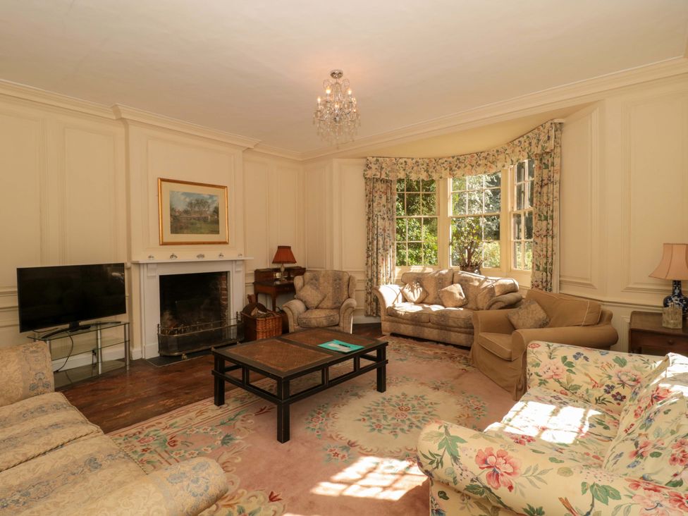 A living room with sofas and a television at The West Wing 