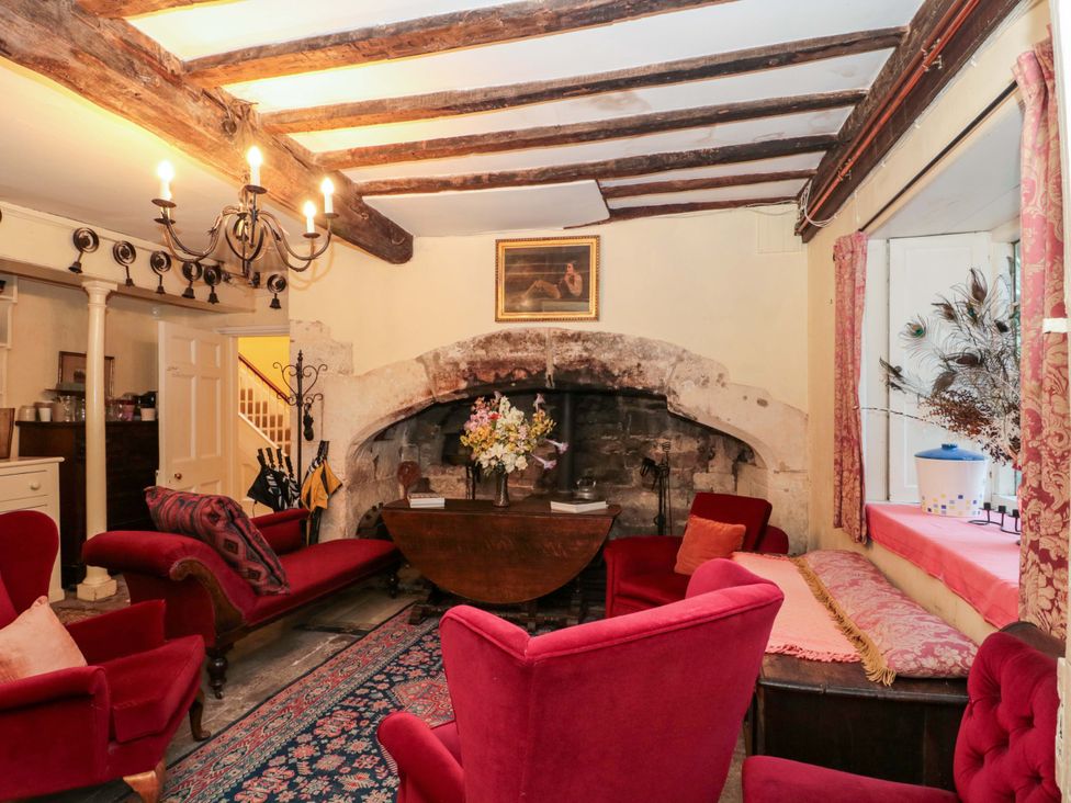 A living room with a fireplace and seating area at The West Wing in 