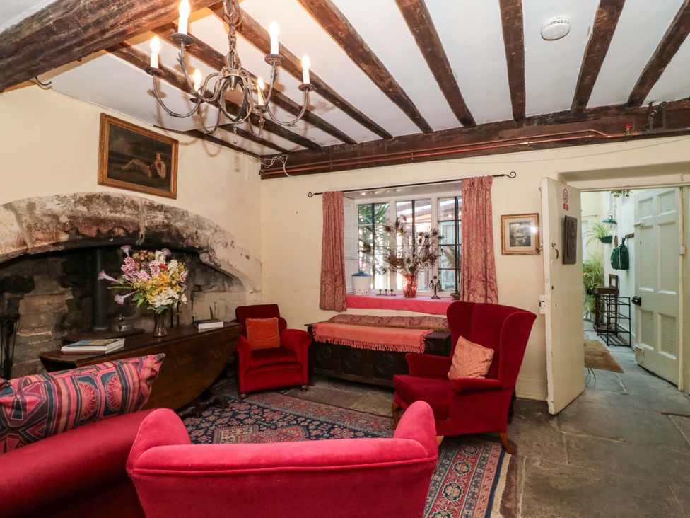 A living room with a fireplace and chandelier at The West Wing