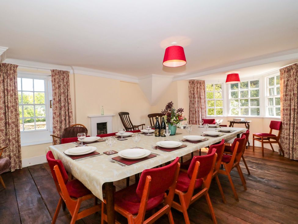 A dining room with a large table set for dinner at The West Wing
