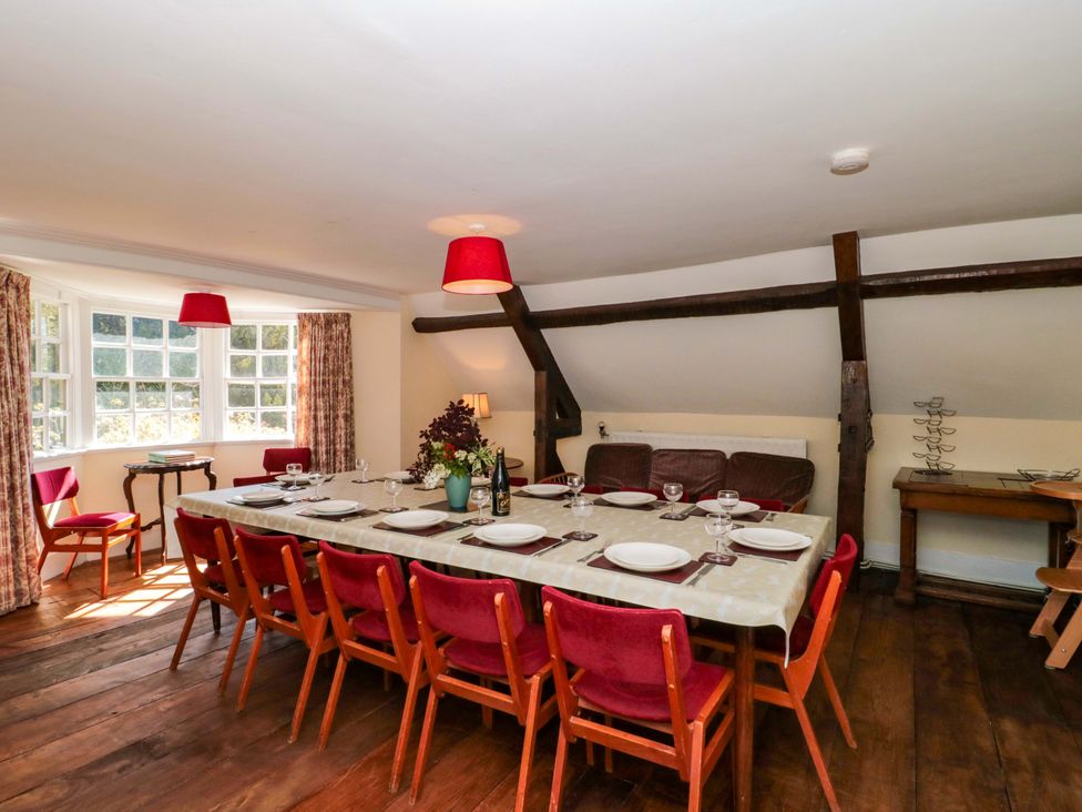 A dining room with a long table and chairs at The West Wing