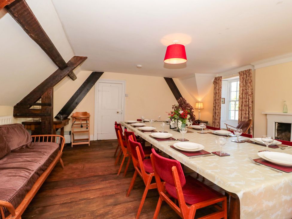 A dining room with a large table and chairs at The West Wing 
