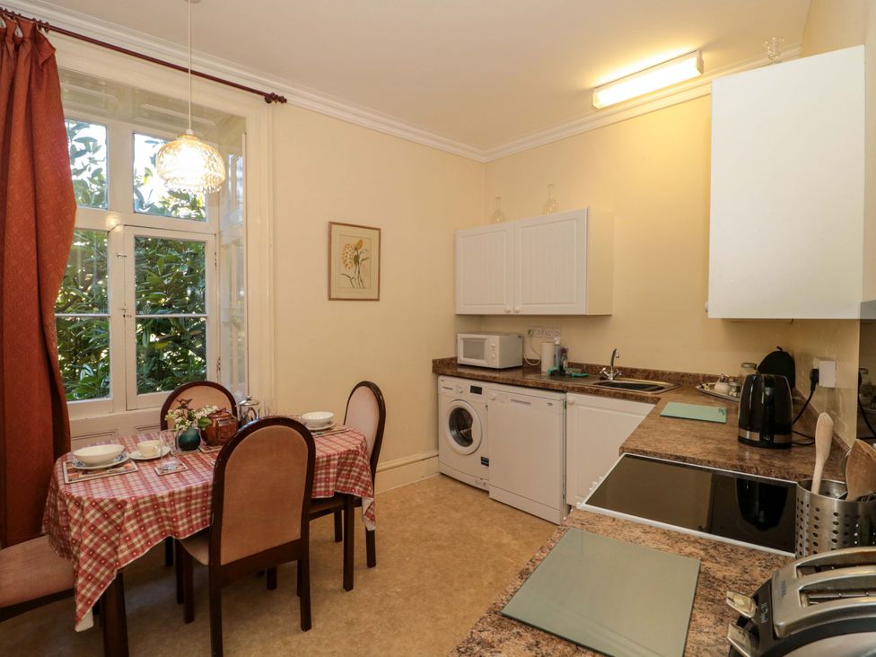 A kitchen with table and chairs at The West Wing