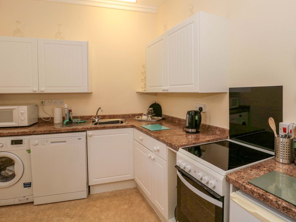 A kitchen with appliances and countertop at The West Wing