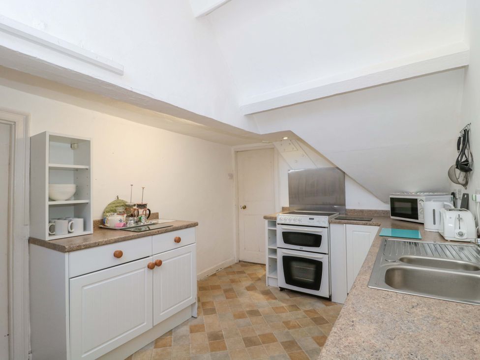 A kitchen with cabinets and appliances at The West Wing