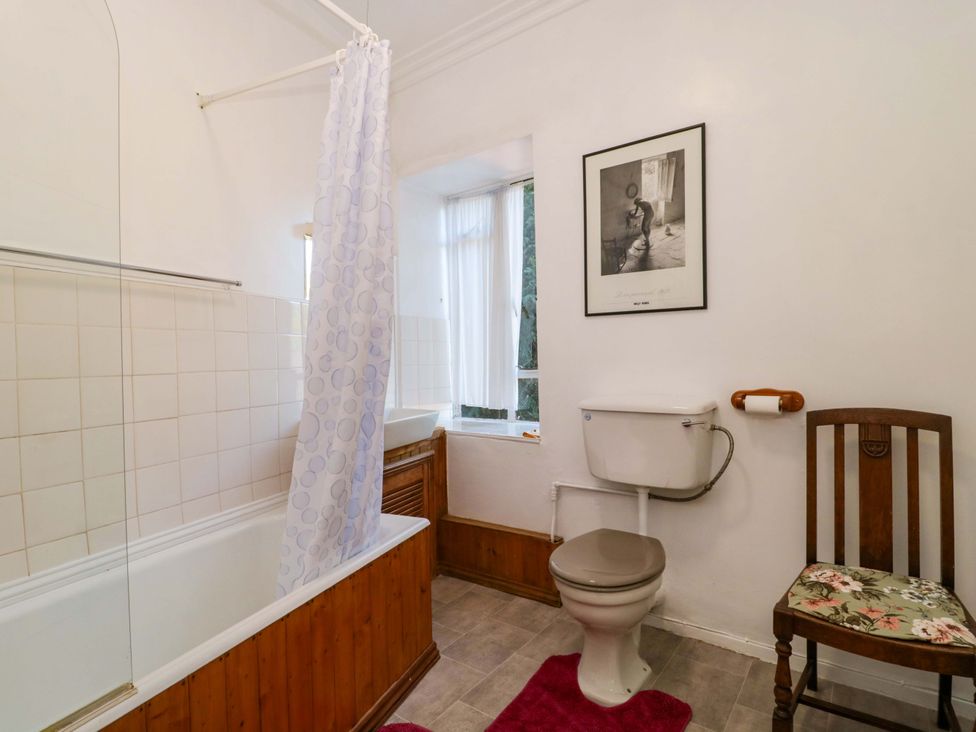 A bathroom with a bathtub, toilet, and sink at The West Wing 
