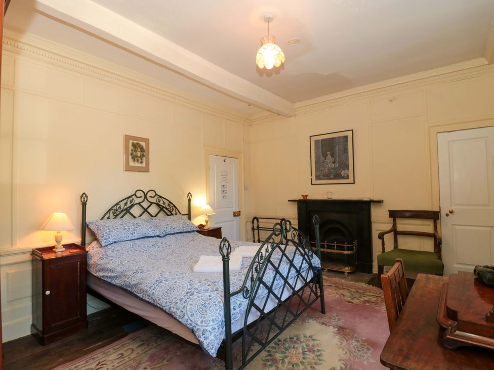 A bedroom with a bed and seating area at The West Wing 