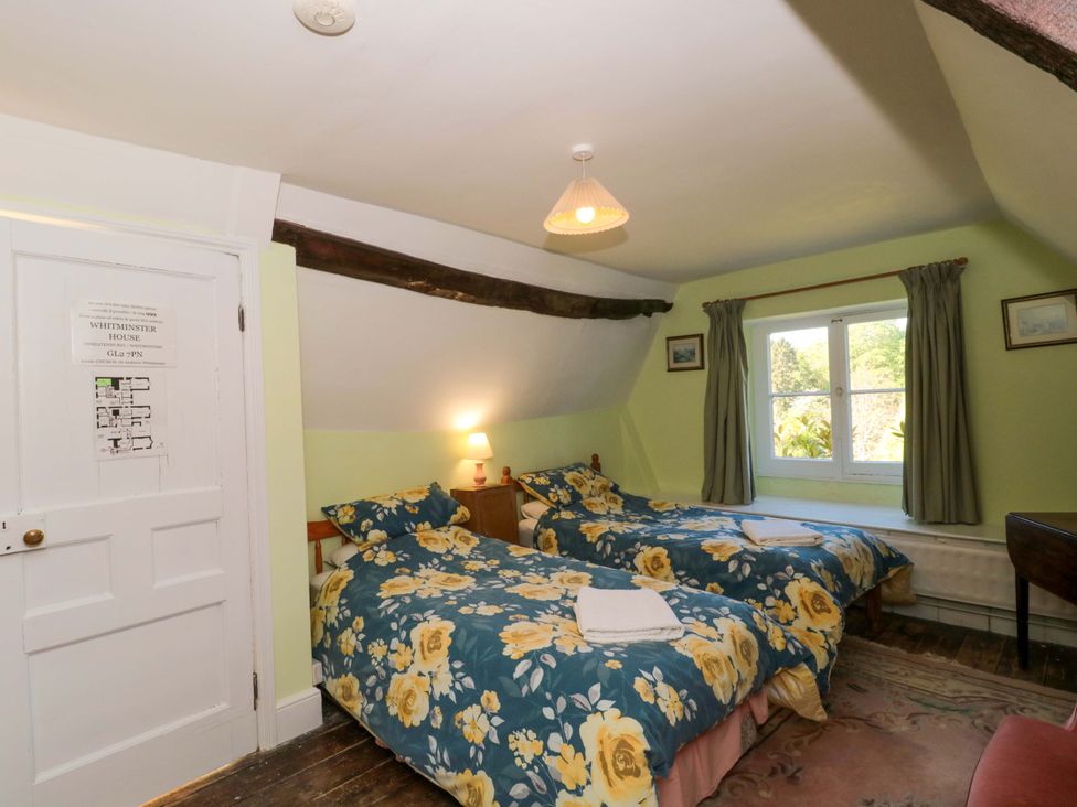 A bedroom with two beds and window at The West Wing