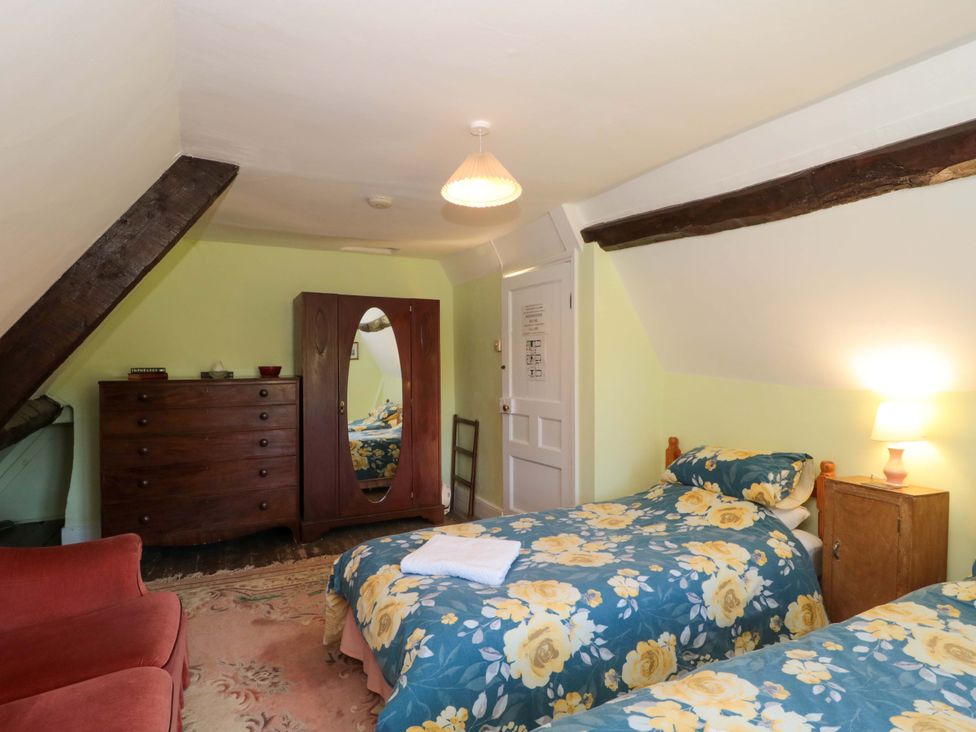 A bedroom with beds and furniture at The West Wing